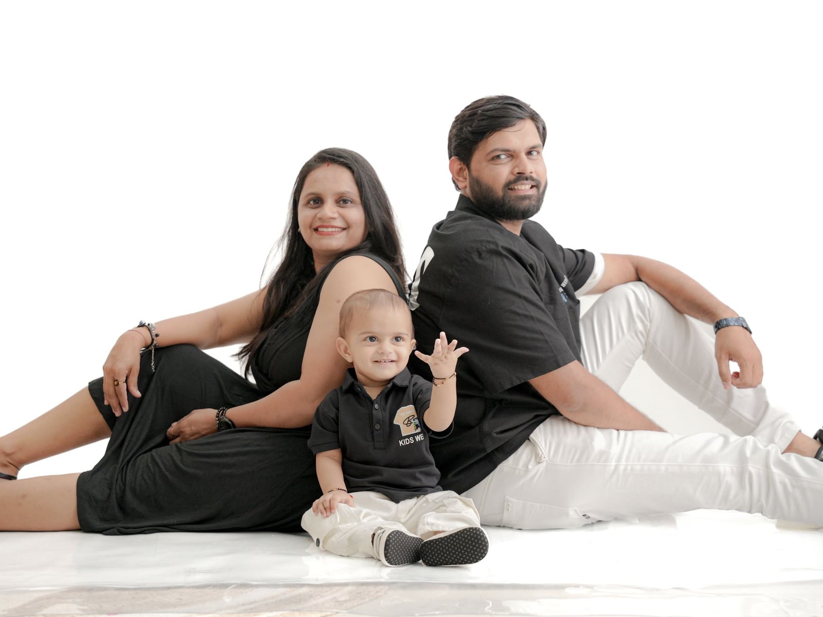 A joyful Australian family posing together during a bright and airy studio photography session.
