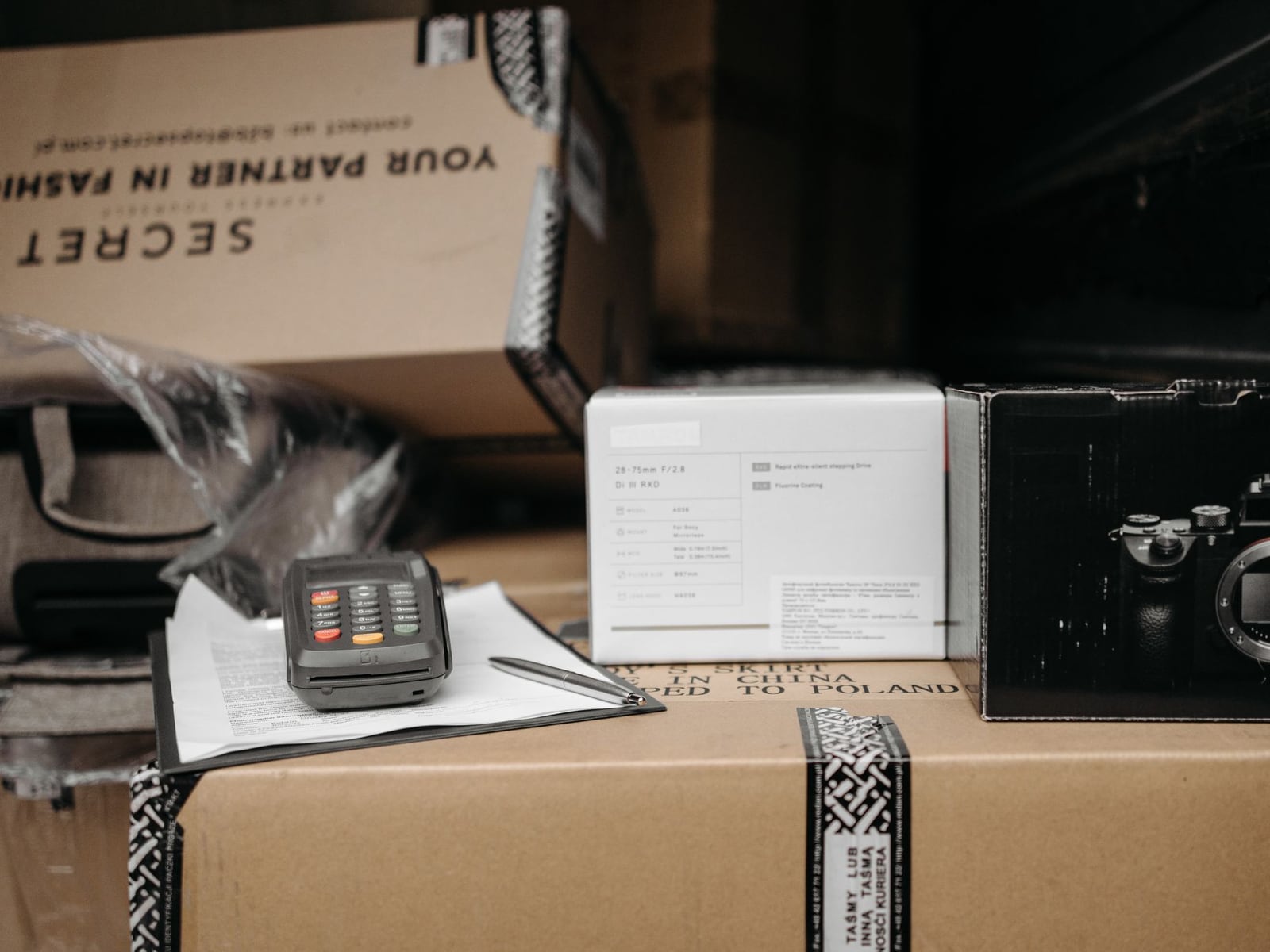 Hands carefully packing a product for shipment to a photography studio.